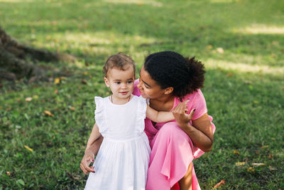 Mother and girl on field