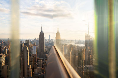 Usa, new york, new york city, midtown manhattan at sunset seen through window