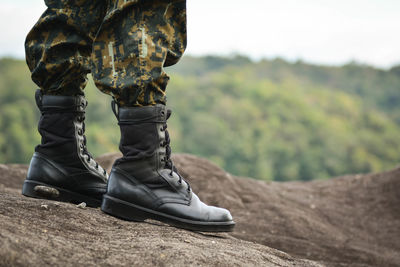 Low section of solider standing on rock