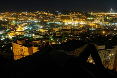 Illuminated cityscape against sky at night