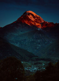 Scenic view of snowcapped mountains against sky at night