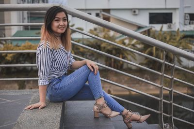 Young woman sitting on staircase