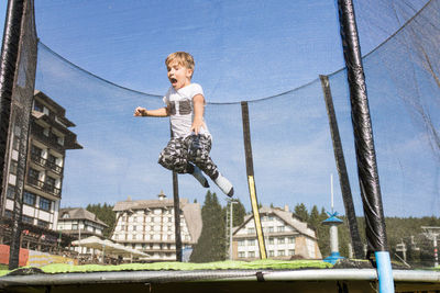 Boy jumping on trampoline