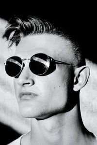 Close-up of young man wearing sunglasses during sunny day
