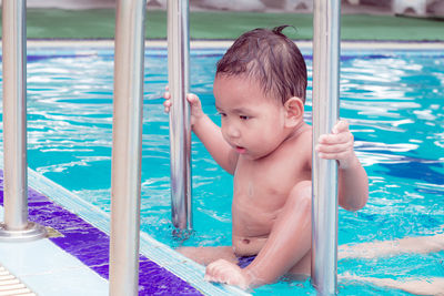 Boy looking at swimming pool