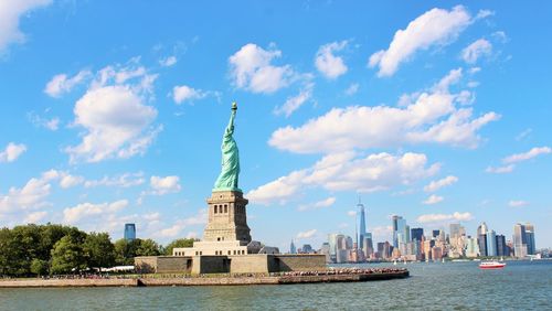 Statue of liberty with city in background