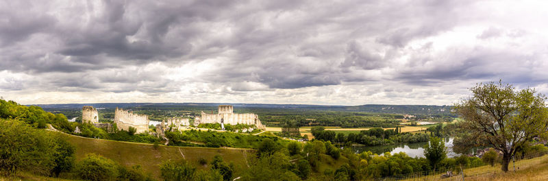 Panoramic view of trees and buildings against sky