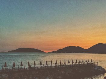 Scenic view of sea against clear sky during sunset