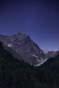 Scenic view of mountains against sky at night