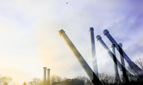 Low angle view of smoke stack against sky