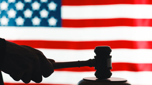 Close-up of man holding american flag