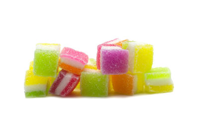 Close-up of multi colored candies against white background