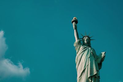 Low angle view of statue against blue sky