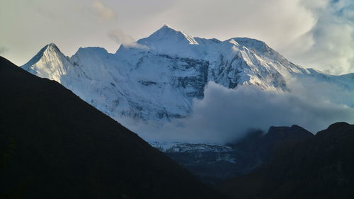 Scenic view of snowcapped mountains against sky