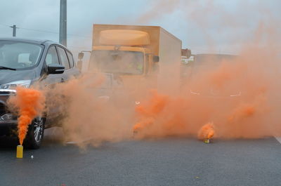 Orange smoke on highway next to cars