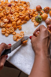 Cropped hand of person preparing food on table