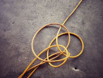 High angle view of yellow cables on concrete