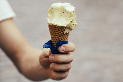 Close-up of hand holding ice cream cone