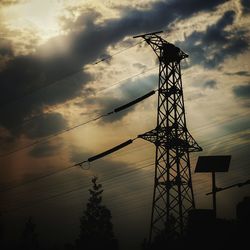 Low angle view of silhouette tower against sky during sunset