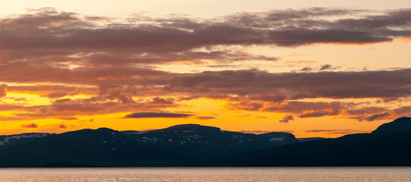 Scenic view of silhouette mountains against sky during sunset