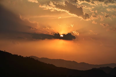 Scenic view of silhouette mountains against sky during sunset