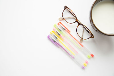 Close-up of colored pencils over white background