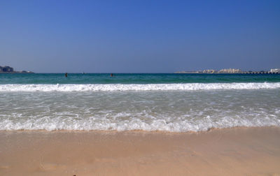 Scenic view of sea against clear blue sky