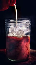 Close-up of ice cream in glass jar on table