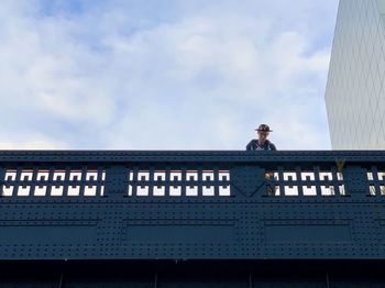 Low angle view of man against building in city