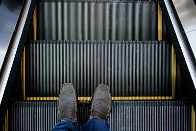 Low section of man on escalator