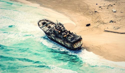 Container ship in water against sky