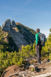 Woman enjoying the view at alpine landscape in autumn, osterhorn mountain range, salzburg, austria