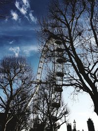Low angle view of bare trees against sky