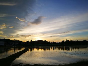 Scenic view of lake against sky during sunset