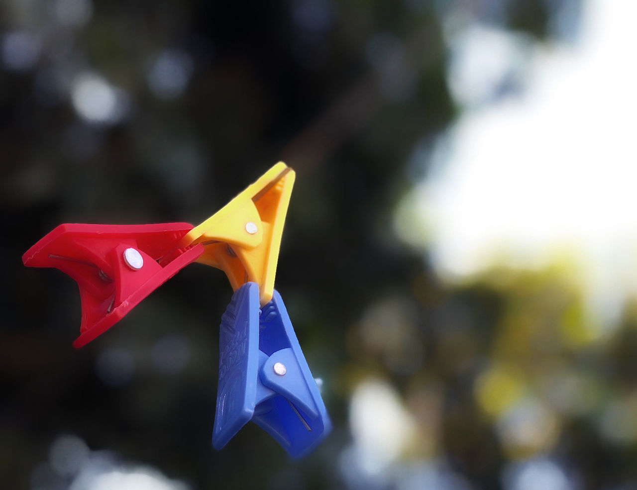 CLOSE-UP OF PAPER TOY HANGING ON ROPE
