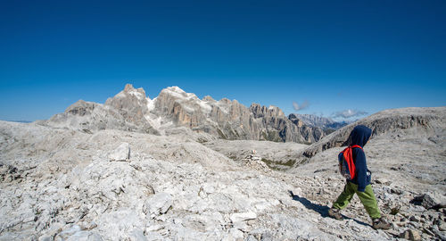 A boy walking in the nature of dolomites