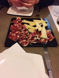 High angle view of person preparing food on cutting board