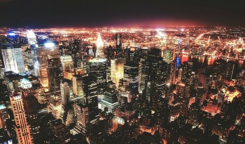 High angle view of illuminated city buildings at night