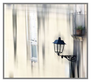 Lamp post on glass window of building