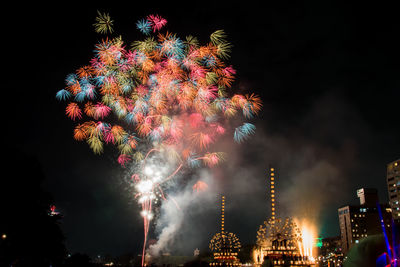 Low angle view of firework display at night