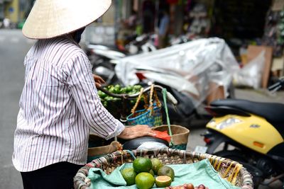 Midsection of man with umbrella in market stall