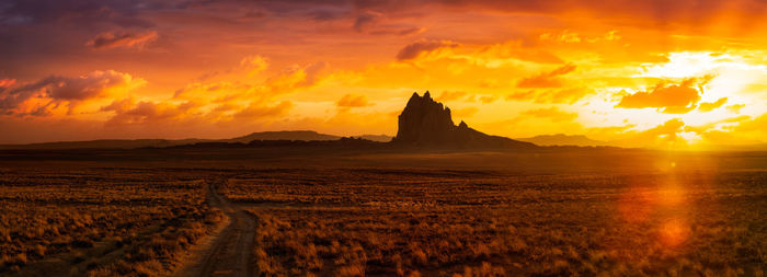 Scenic view of land against sky during sunset