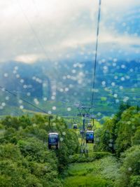 Overhead cable car on land against sky