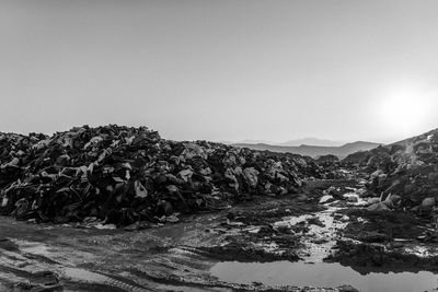 Life jackets at garbage dump against sky