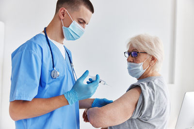 Female doctor examining patient at clinic