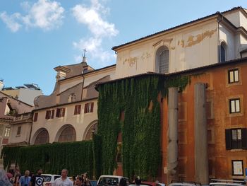 Buildings in town against sky in city