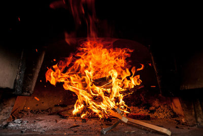 Bonfire on wooden log at night