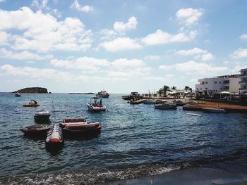 Boats sailing in sea against sky