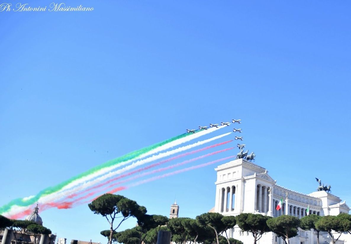 sky, architecture, nature, blue, building exterior, built structure, clear sky, day, sunny, travel destinations, arts culture and entertainment, city, tree, outdoors, copy space, plant, motion, building, no people, flag, multi colored, travel