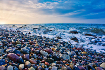 View of pebbles on beach against sky